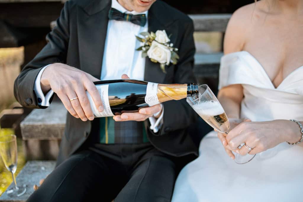 Bilde av brud og brudgom som skåler med champagne under bryllupsfeiring i Oslo. Fotograf Heidi Henri.